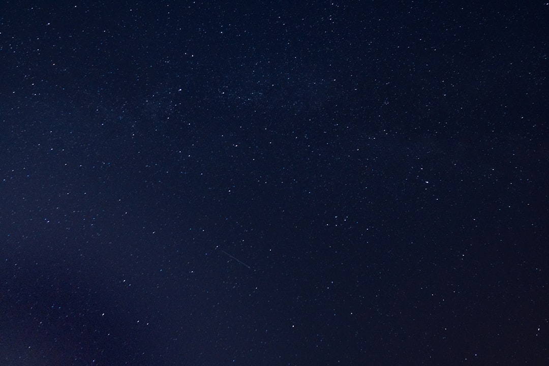 the night sky is full of stars and a few clouds