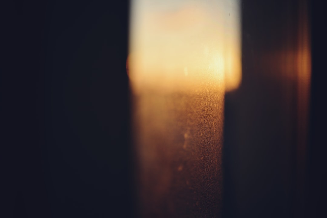 A blurry photo of a window with the sun going down