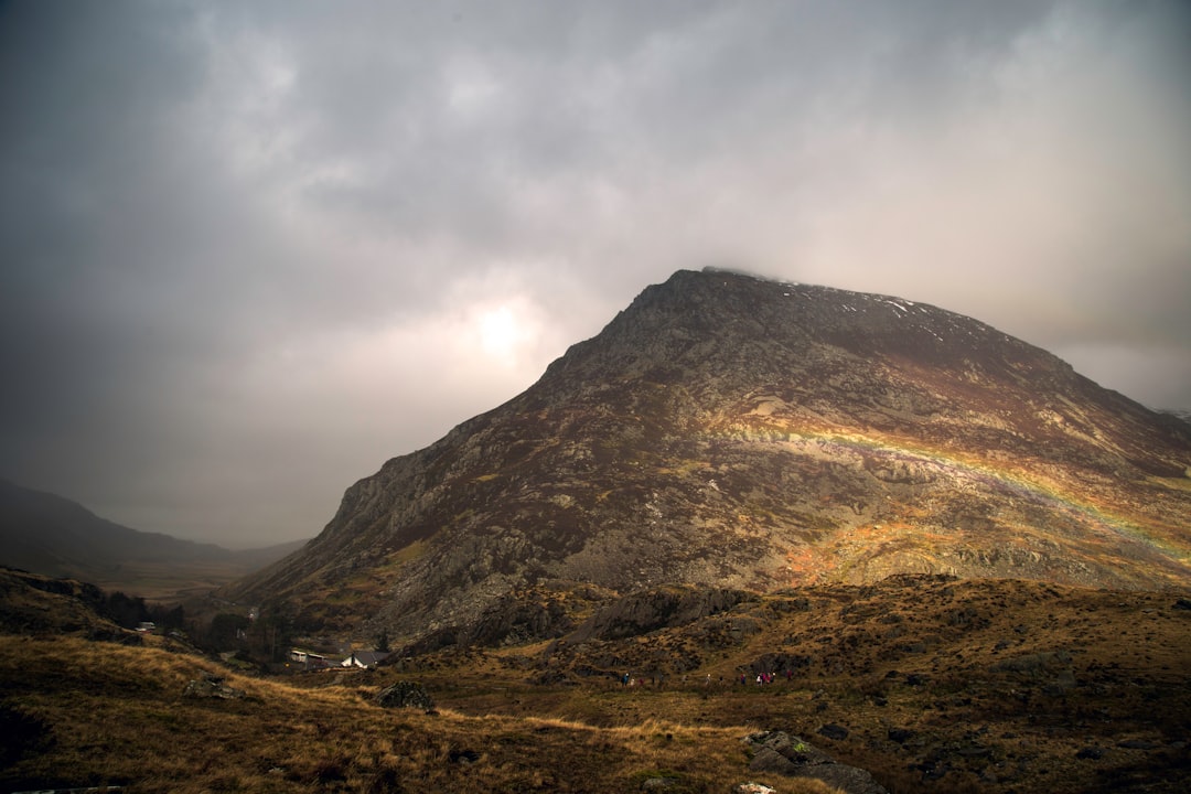 brown mountain peak under white clouds
