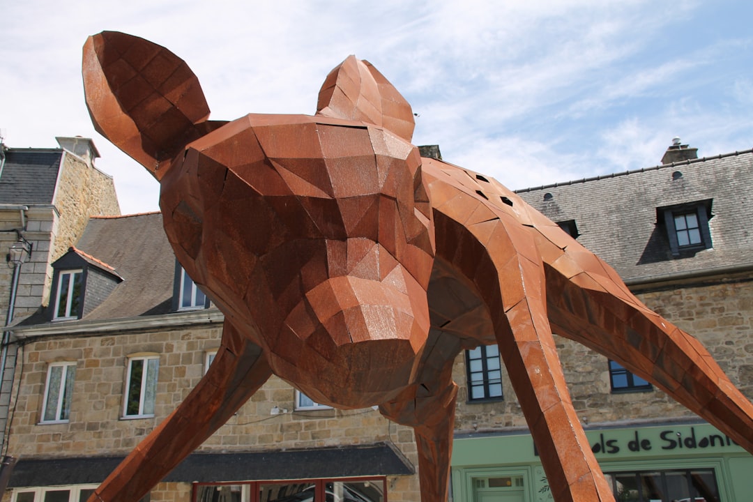 A wooden dog statue in front of a building
