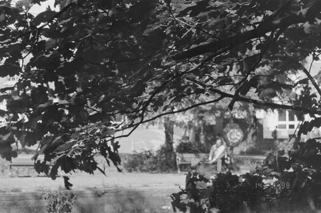 A black and white photo of a person riding a bike